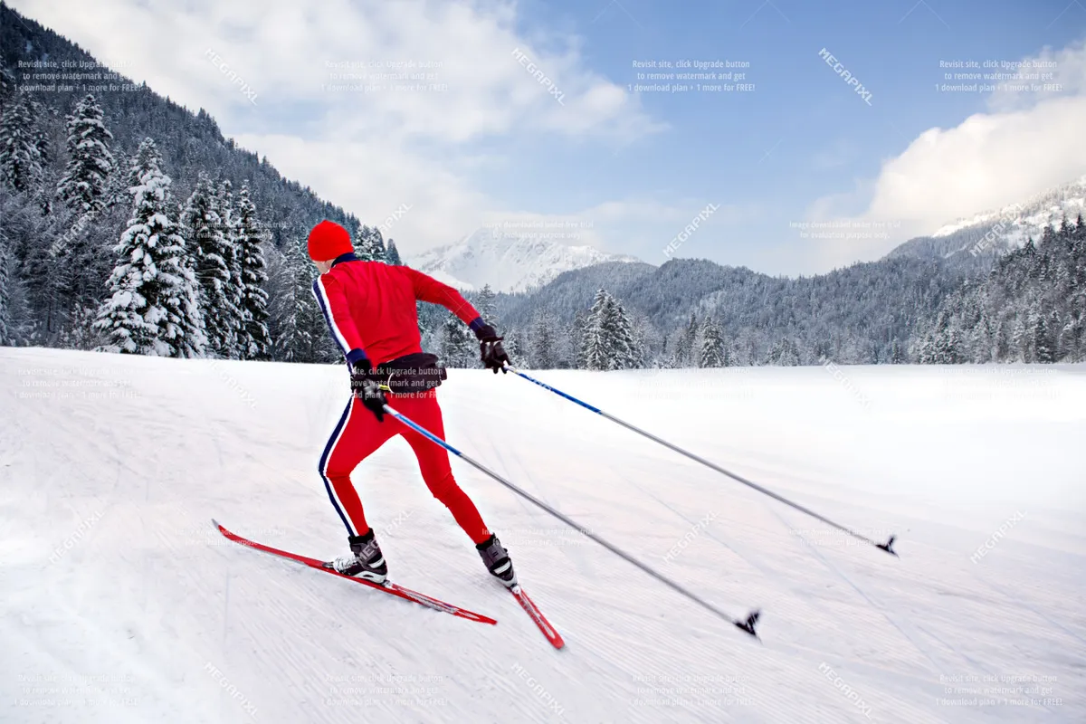 A skier glides across a pristine, snow-covered landscape, framed by a dramatic mountain backdrop. The scene is active and invigorating, emphasizing winter sports and the natural beauty of the area.